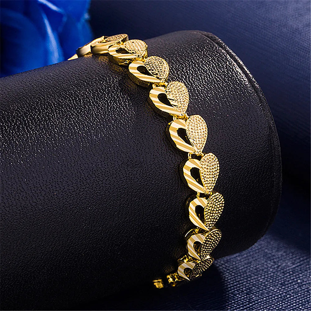 Gold-plated copper heart-shaped bracelet on neutral background showing 18.5cm length