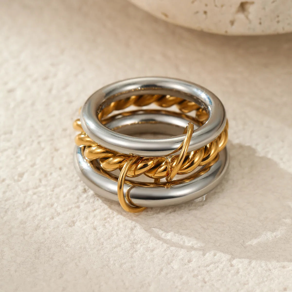 A stacked stainless steel ring set with 18K gold plating in an exaggerated design for women.