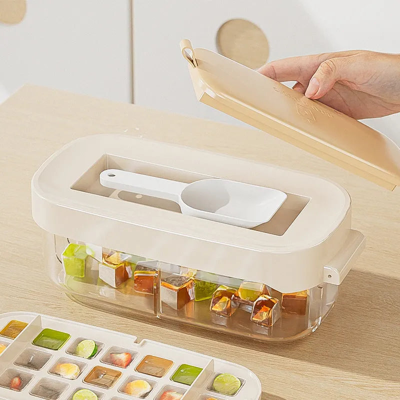 A high-capacity blue ice cube tray with a leverage-action lid and a stored ice shovel.