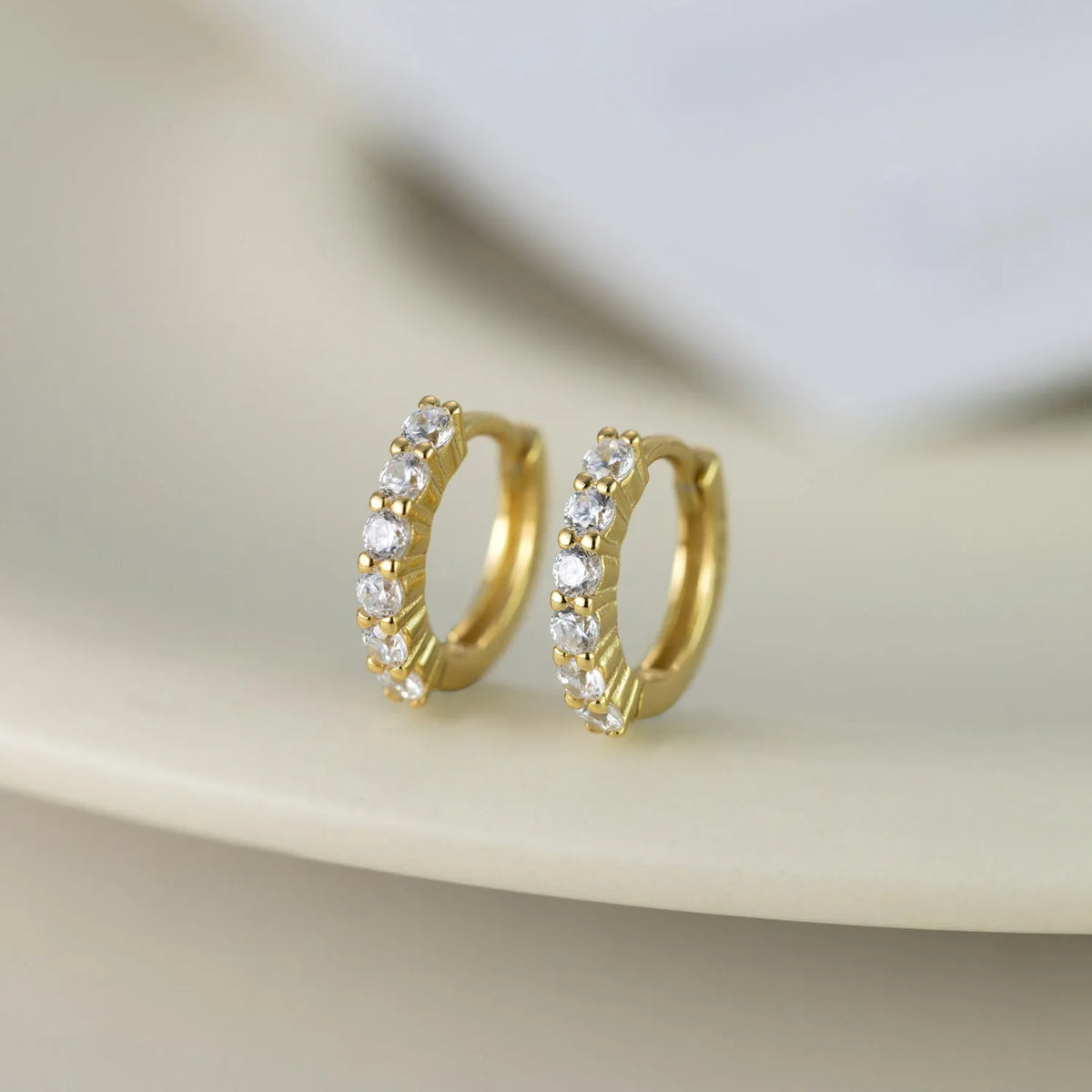 925 silver geometric stud earrings in white gold finish on white background