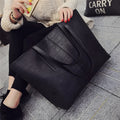 Simple fashion shoulder bag handbag in black or grey with adjustable crossbody strap and top handle
