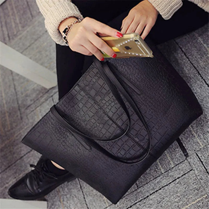 Simple fashion shoulder bag handbag in black or grey with adjustable crossbody strap and top handle