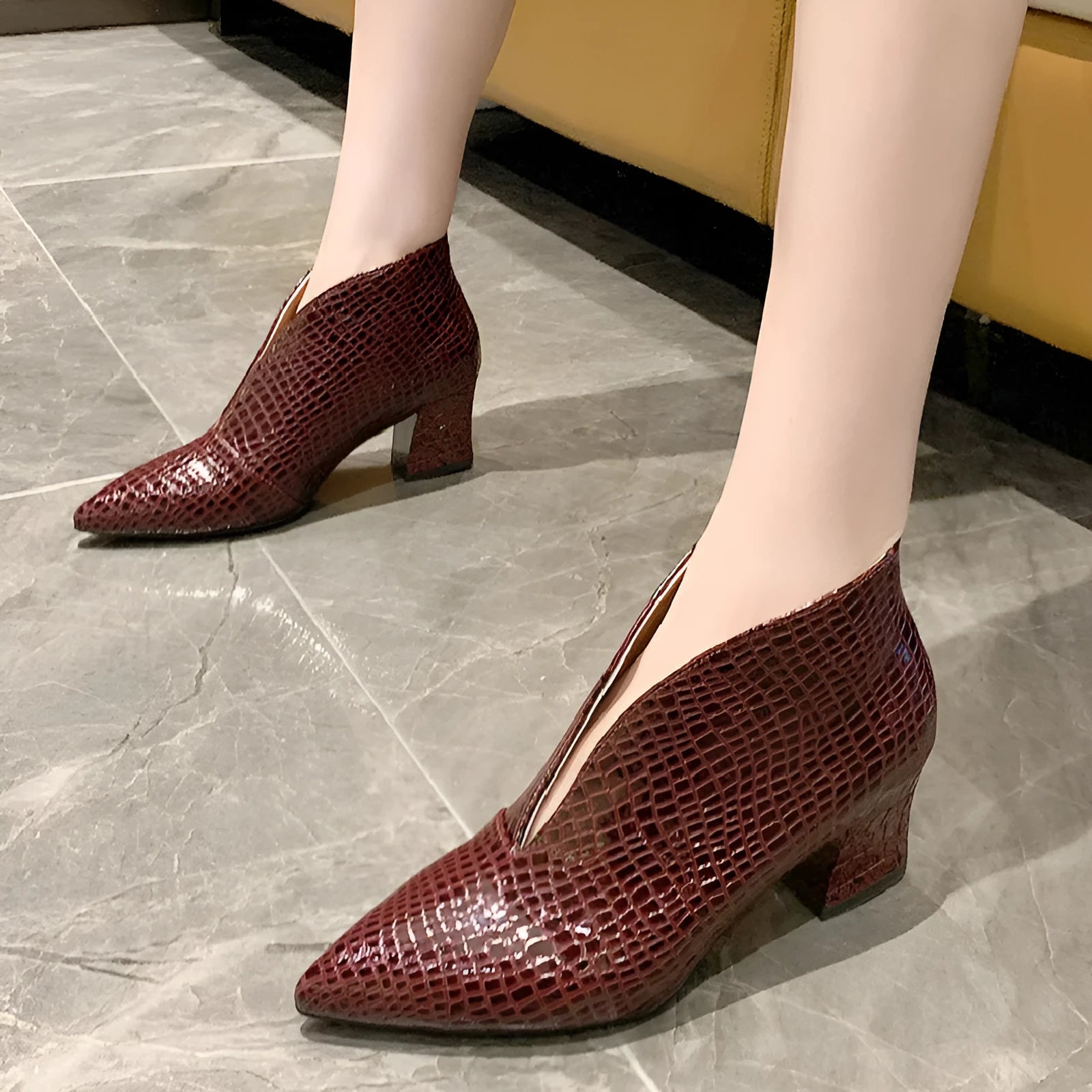 Women's black V cut pointed toe ankle boots with embossed detailing and chunky heel