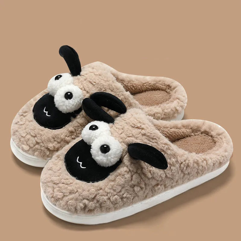 Brown suede slip-on slippers with a PVC sole on a wooden floor.