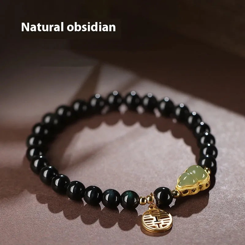 Black obsidian bracelet with a Hetian jade gourd charm, shown in couple style with geometric beads.