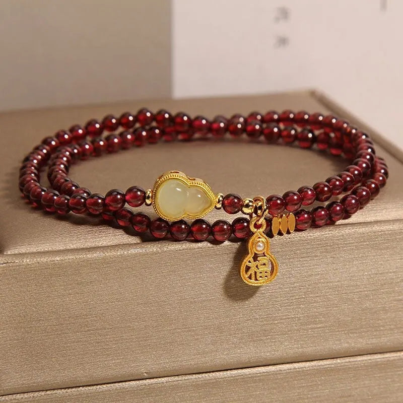 Antique style Chinese bracelet with U-shaped design and floral red garnet imitation gemstones