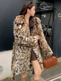 A long faux fur coat with a fox fur-style collar, shown in a street fashion context.