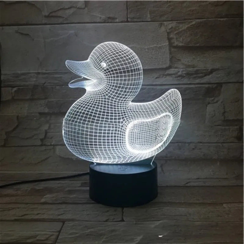 Little Yellow Duck shaped 3D acrylic night light with remote control on a table.