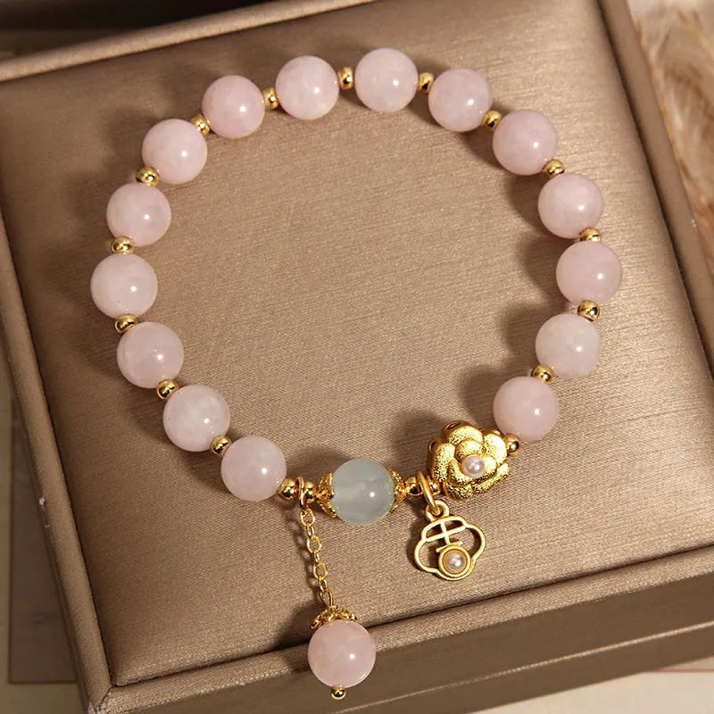 Women's pink crystal flower bracelet with detailed floral bead design on wrist