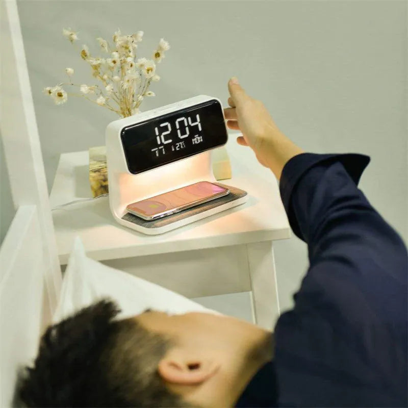 White bedside lamp with integrated wireless charging pad and LCD alarm clock display