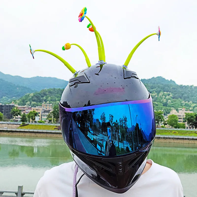 Yellow silicone swinging sunflower decoration with suction cup for helmet attachment.
