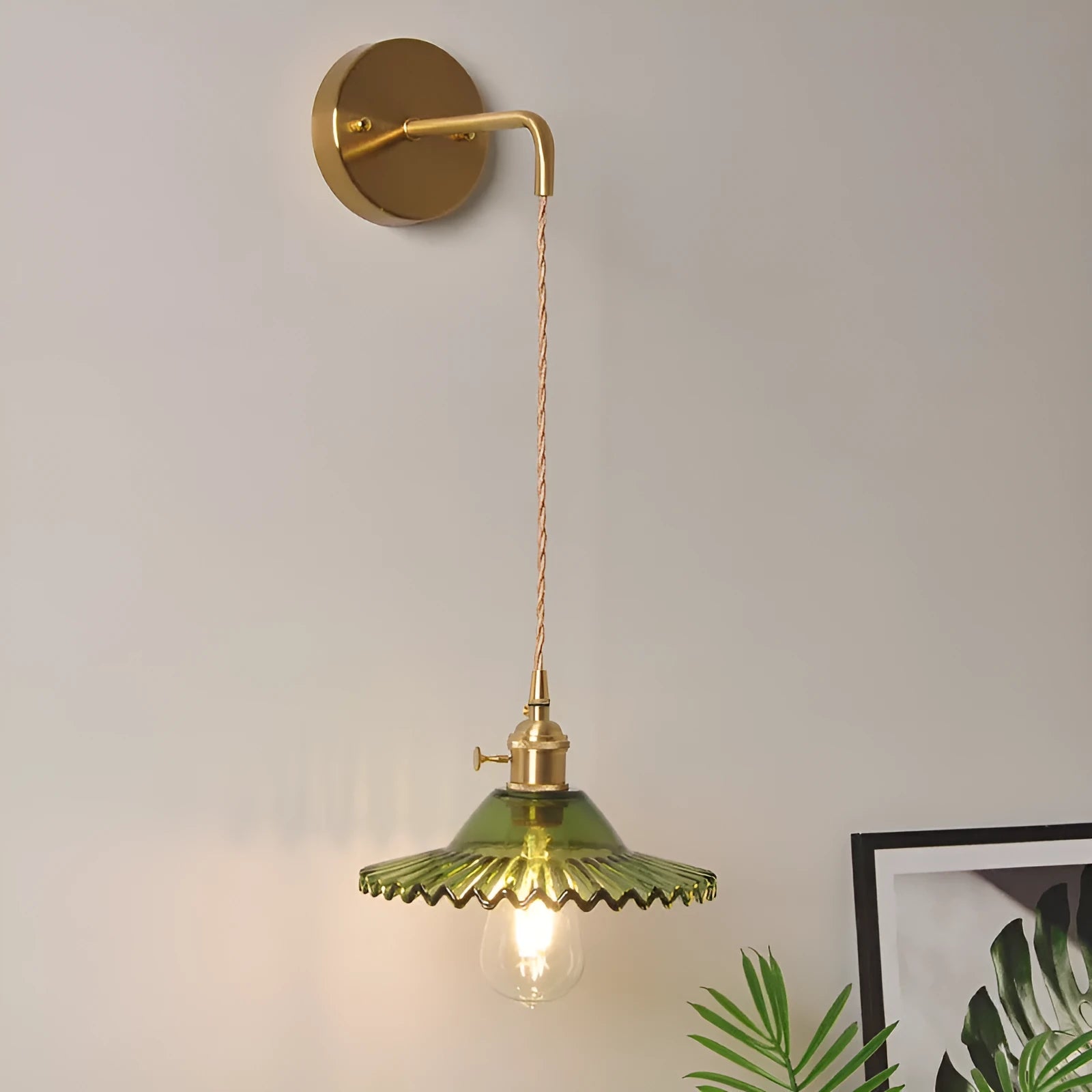 Retro brass lotus wall lamp with adjustable copper wire and white glass shade mounted on a wall.