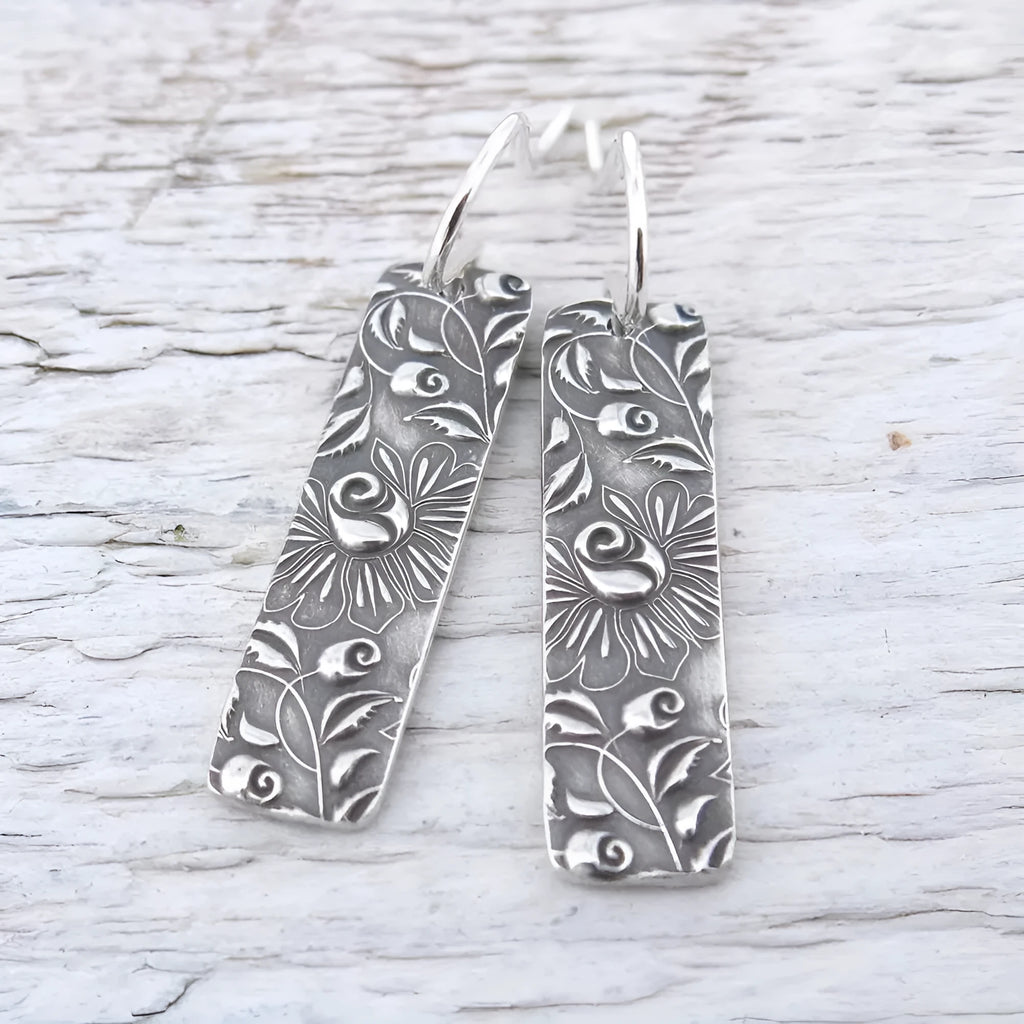 Silver long earrings with geometric shapes and carved vine detailing in zinc alloy construction