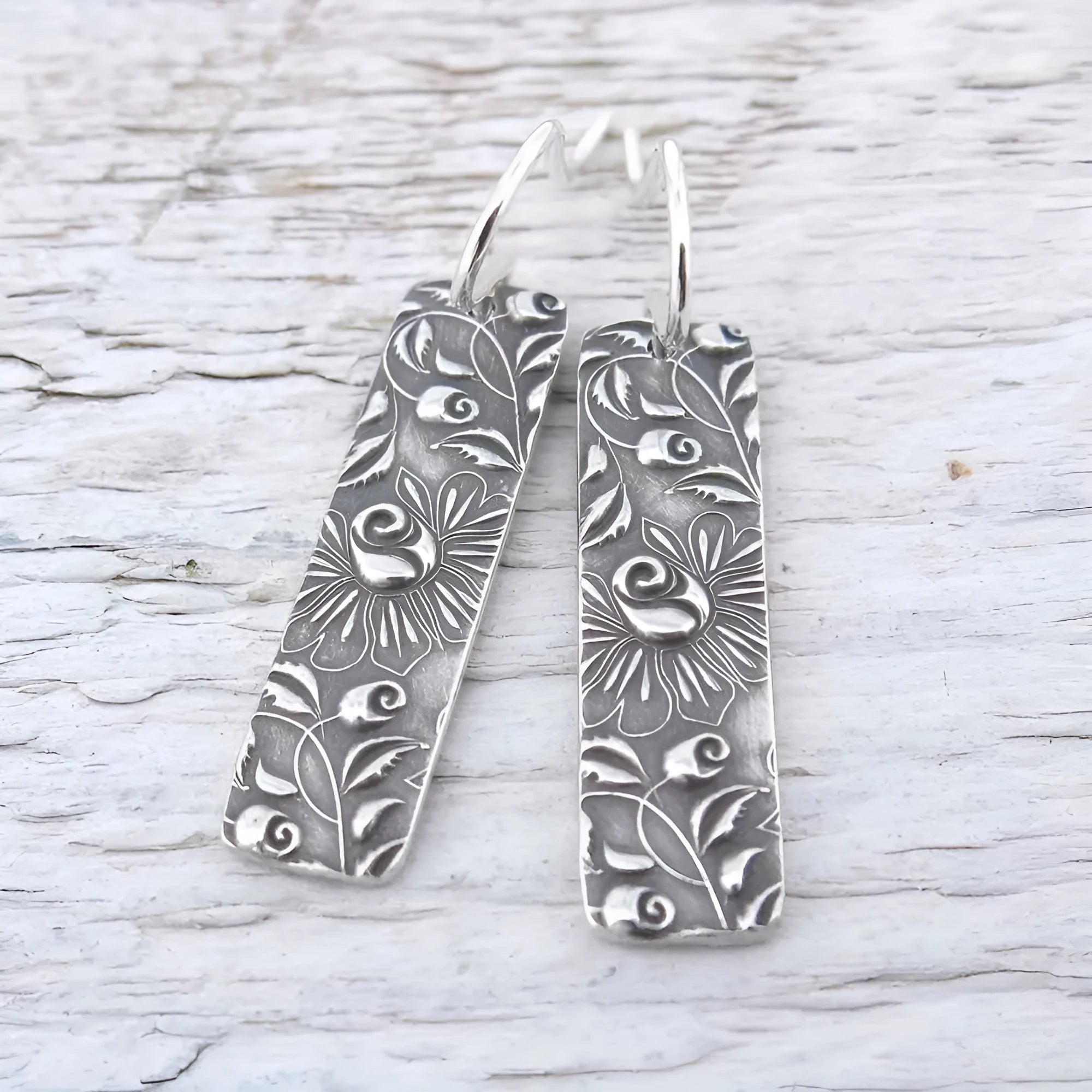 Silver long earrings with geometric shapes and carved vine detailing in zinc alloy construction