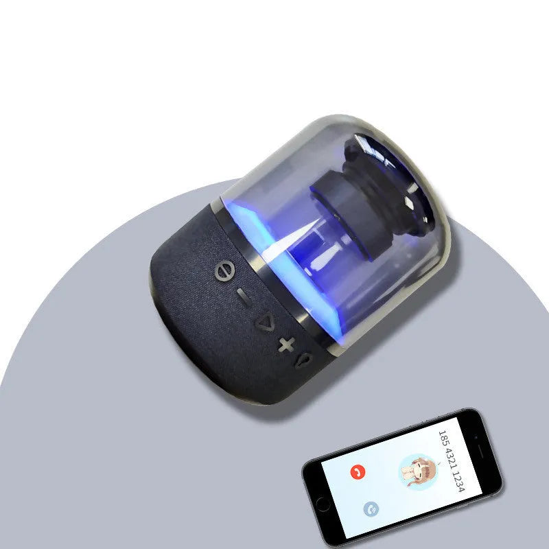 Black portable Bluetooth speaker with multi-colour LED light ring and control buttons on top.
