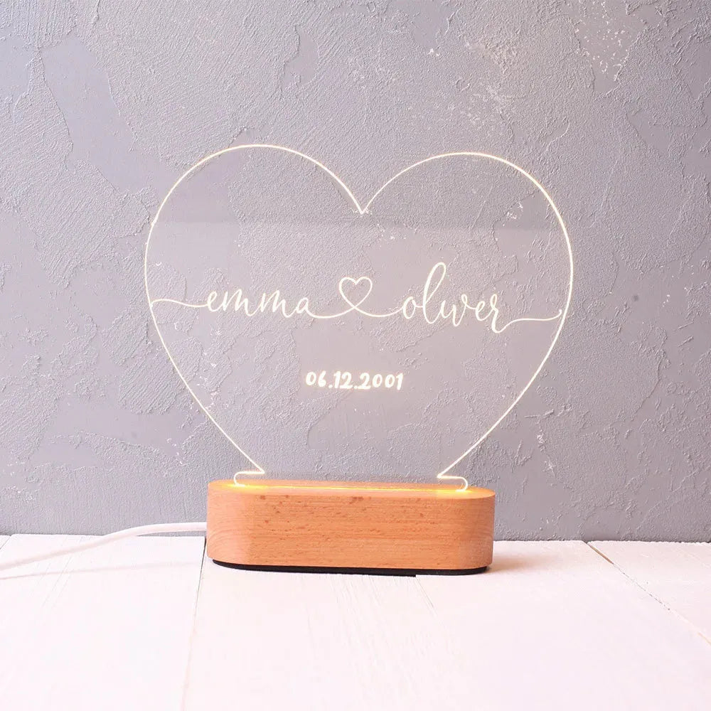 Custom transparent acrylic night light engraved with personal names and a date.