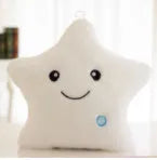 Colourful glowing five-pointed star plush pillow on a dark background, showing soft texture and LED illumination