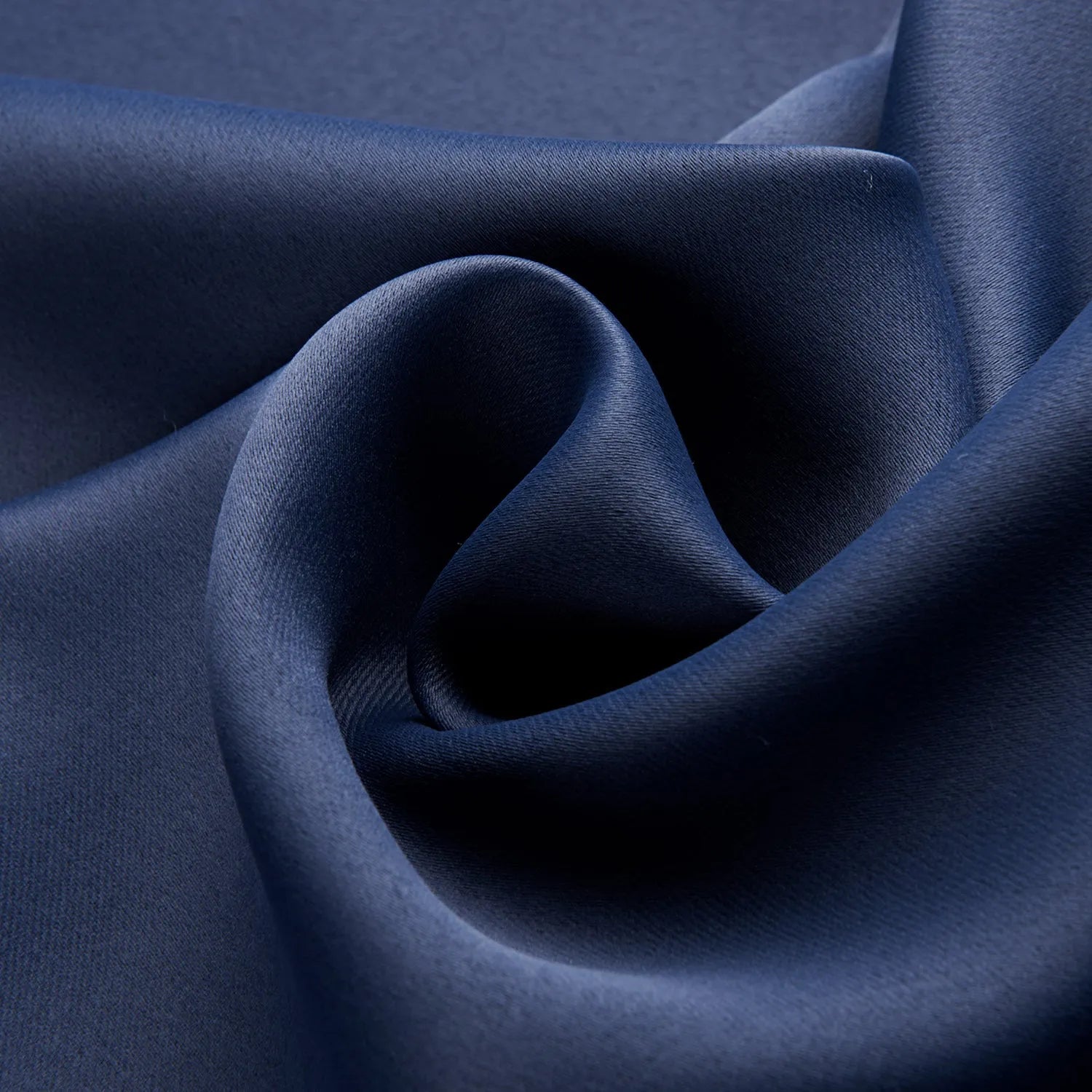 Dark navy blue blackout curtain hanging, showing its modern simple style and light-blocking fabric.