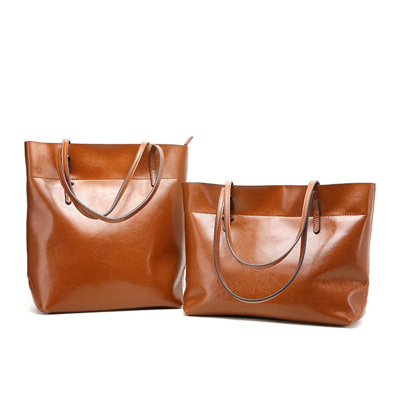Brown waxed cowhide leather women's crossbody handbag with a structured shape and a front flap.