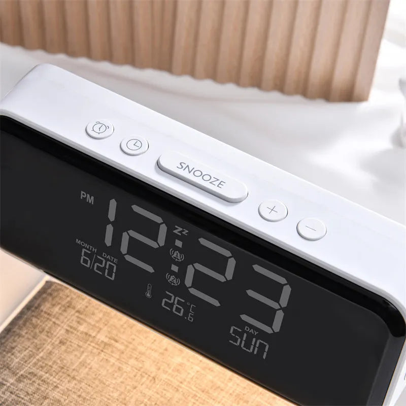 White bedside lamp with integrated wireless charging pad and LCD alarm clock display
