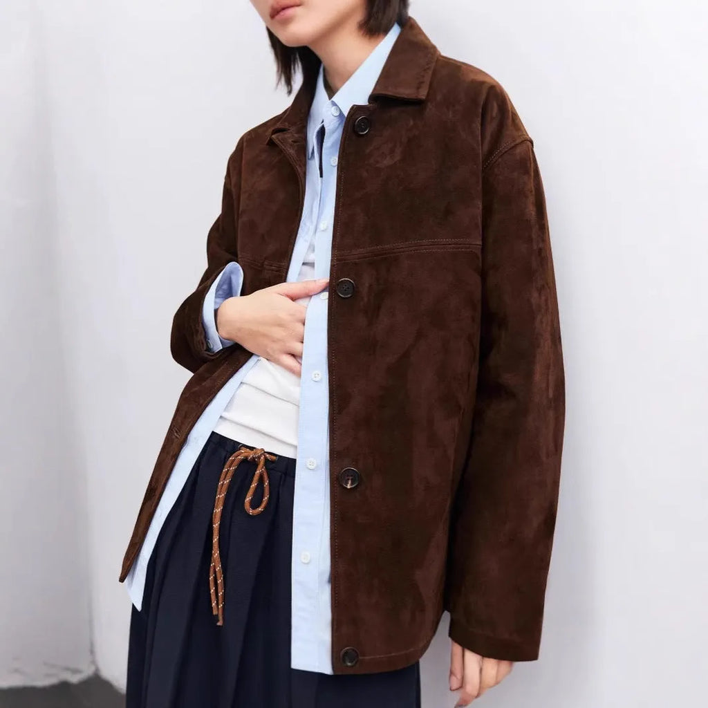 Yellow brown mid-length cashmere coat with a Peter Pan collar and decorative leather stitching on the front.
