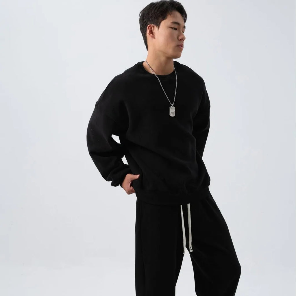 Men's black polar fleece sports suit set with long sleeve coat and loose trousers on a hanger.