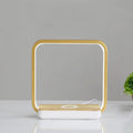 LED desk lamp with wireless charging base in round white finish on a wooden desk