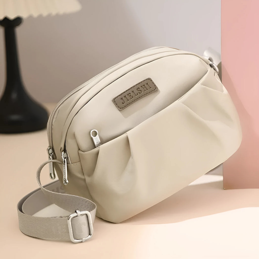 Pleated Oxford cloth shoulder messenger bag in horizontal square shape with cross-body strap