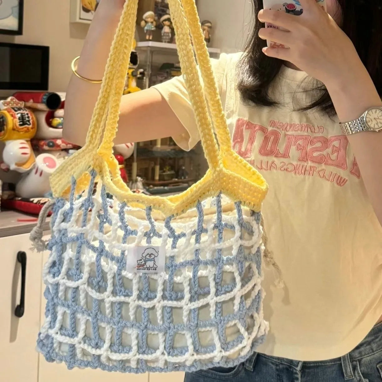 Handwoven wool summer tote bag with a floral patterned design.