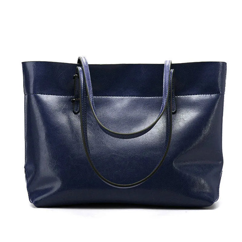 Brown waxed cowhide leather women's crossbody handbag with a structured shape and a front flap.