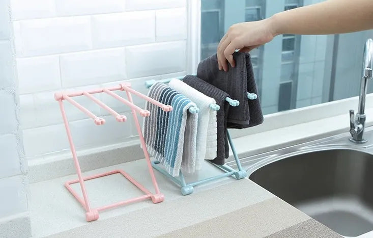Foldable vertical dishcloth shelf in light blue with punch-free installation for kitchen organisation.