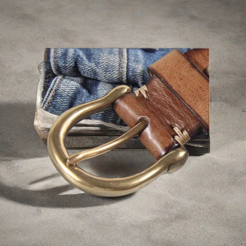 Men's brown leather belt with copper pin buckle on a flat surface