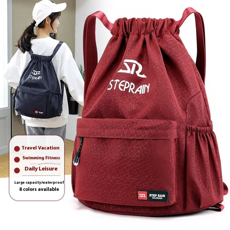 Lightweight solid colour Oxford cloth backpack with drawstring closure and double shoulder straps.