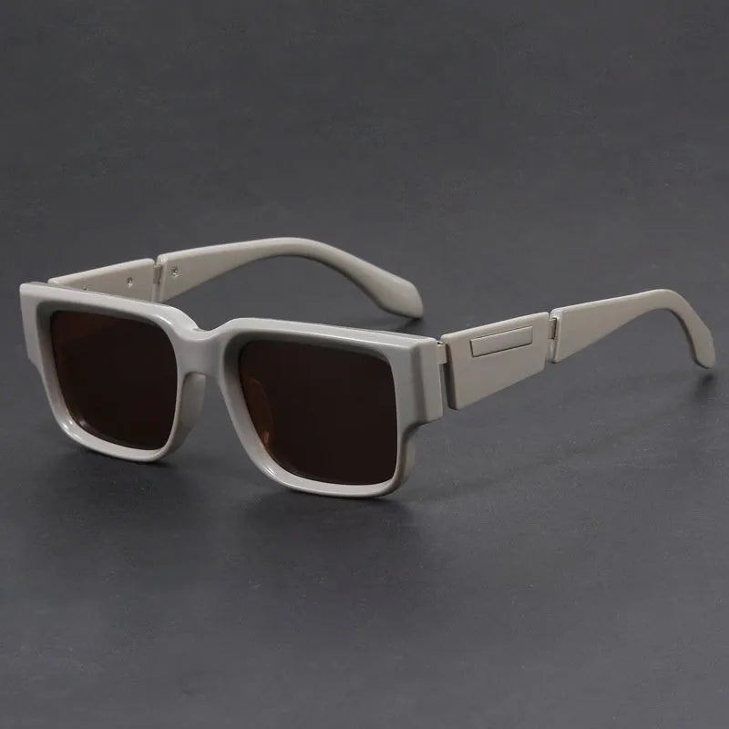 Gray blue square thick frame retro sunglasses with UV-proof lenses on a flat surface.