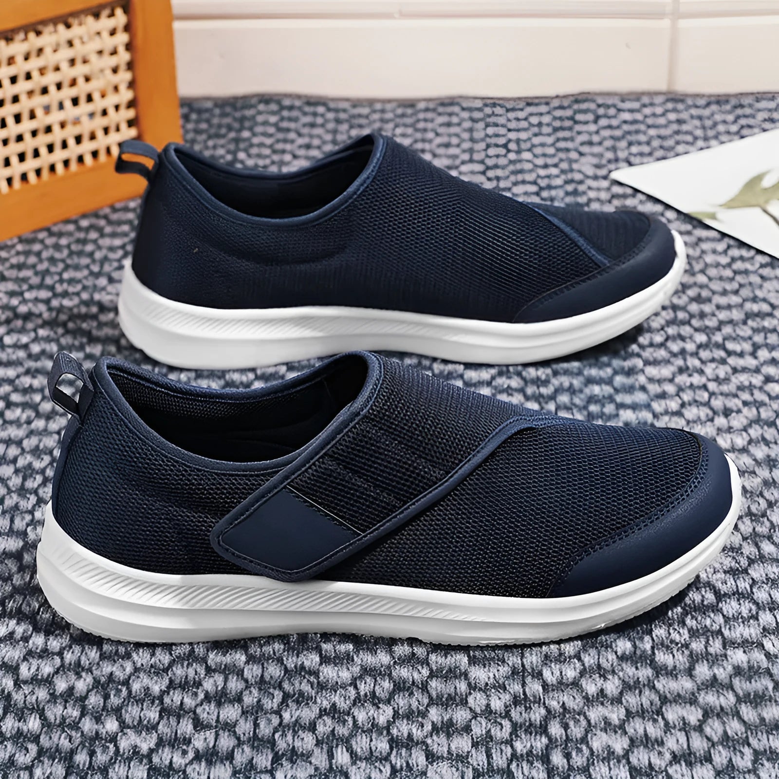 A pair of casual walking shoes with a mesh upper and Velcro strap closure, shown in one of four available colours.