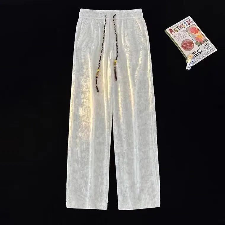 Korean style men's summer pants in black with drooping texture and folding craft detailing