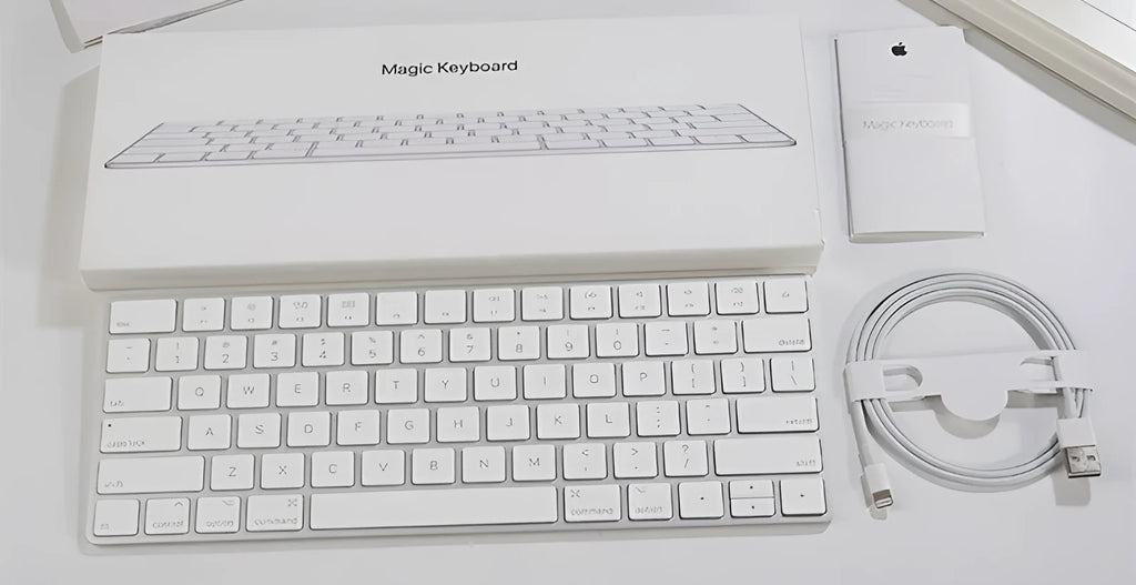 White Apple Bluetooth wireless keyboard with ultra-thin metal casing on a desk