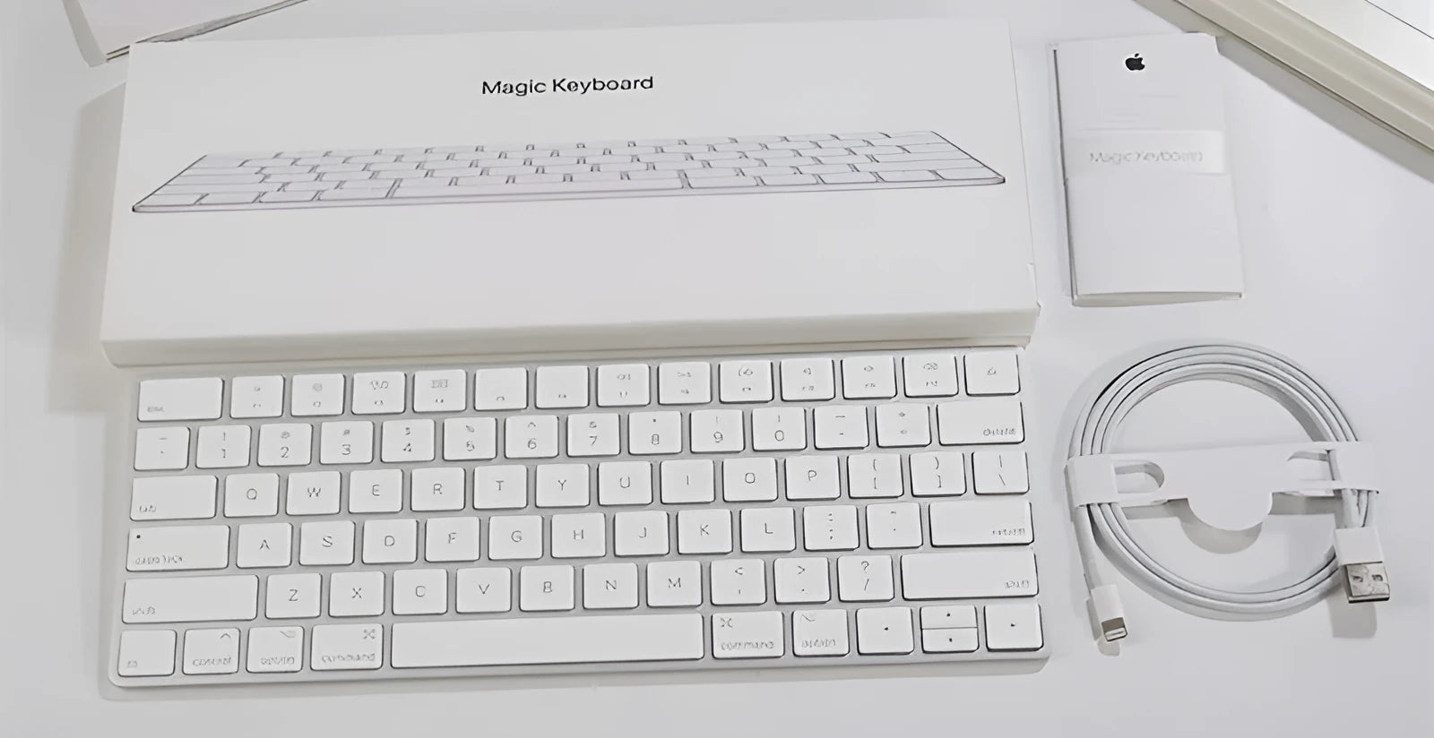 White Apple Bluetooth wireless keyboard with ultra-thin metal casing on a desk