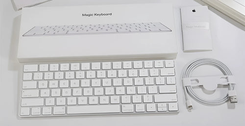 White Apple Bluetooth wireless keyboard with ultra-thin metal casing on a desk