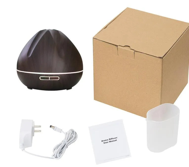 Air humidifier aromatherapy machine with 500ml capacity and light wood finish placed on a desk