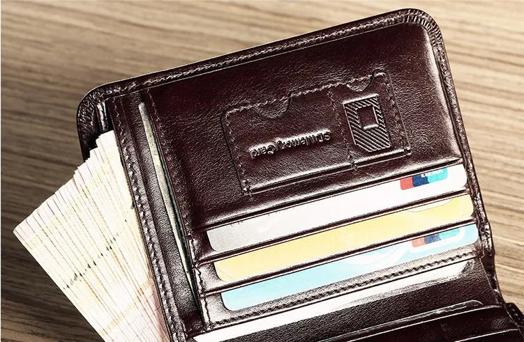 Men's black full-grain leather bifold wallet showing open interior with card slots and an exterior zippered coin pouch.