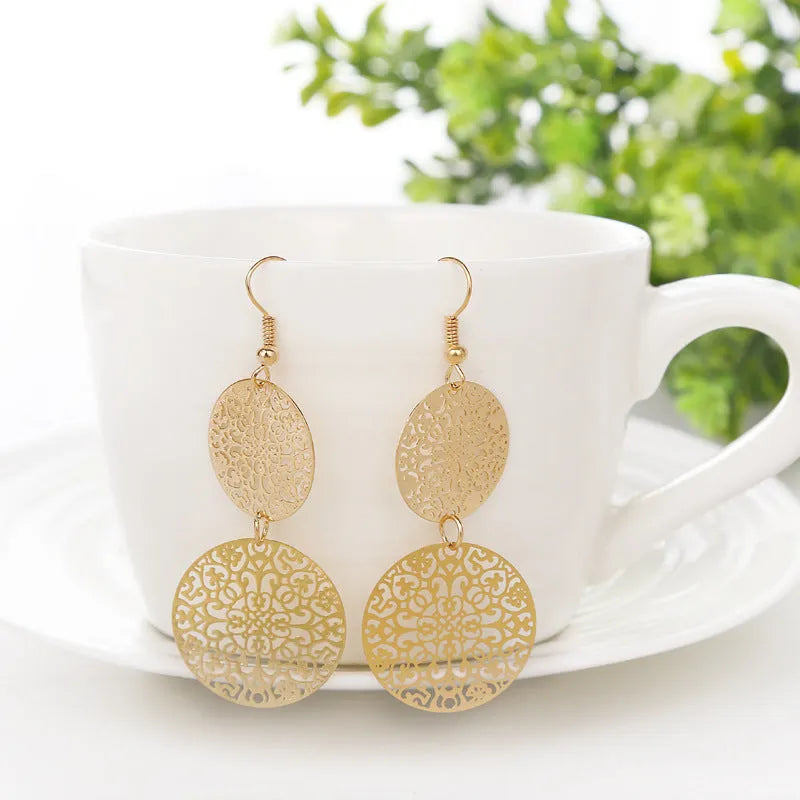 Women's gold round hollow dangle earrings made from zinc alloy, 4.5 by 8 cm, one pair