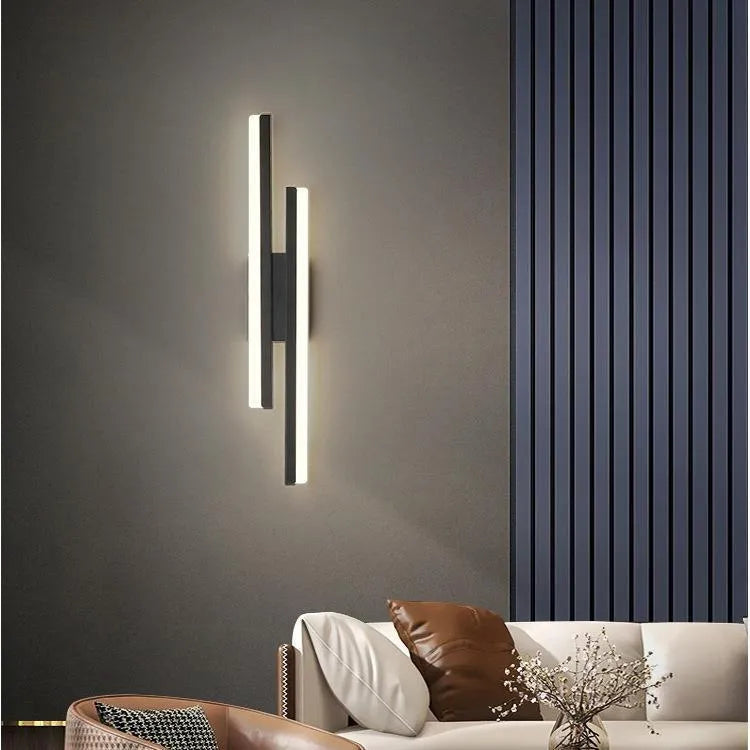 Scandinavian minimalist acrylic LED wall light in black or gold finish on a modern interior wall.