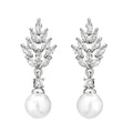 Geometric flower-shaped earrings with micro inlaid zircon and pearl details on a gold-toned metal base.
