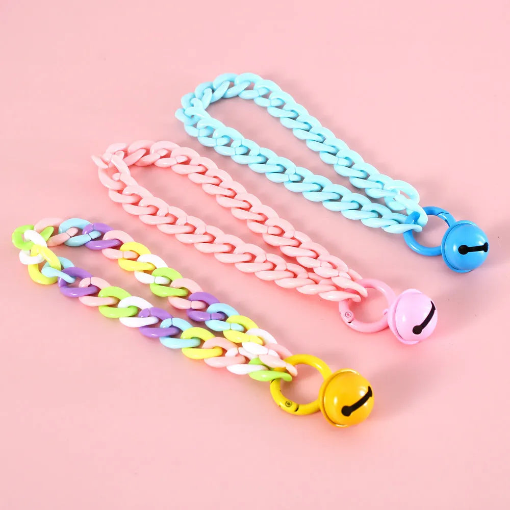 Soft plastic pet collar in pastel macaron candy colours with a chain-link design, shown in S and M sizes.