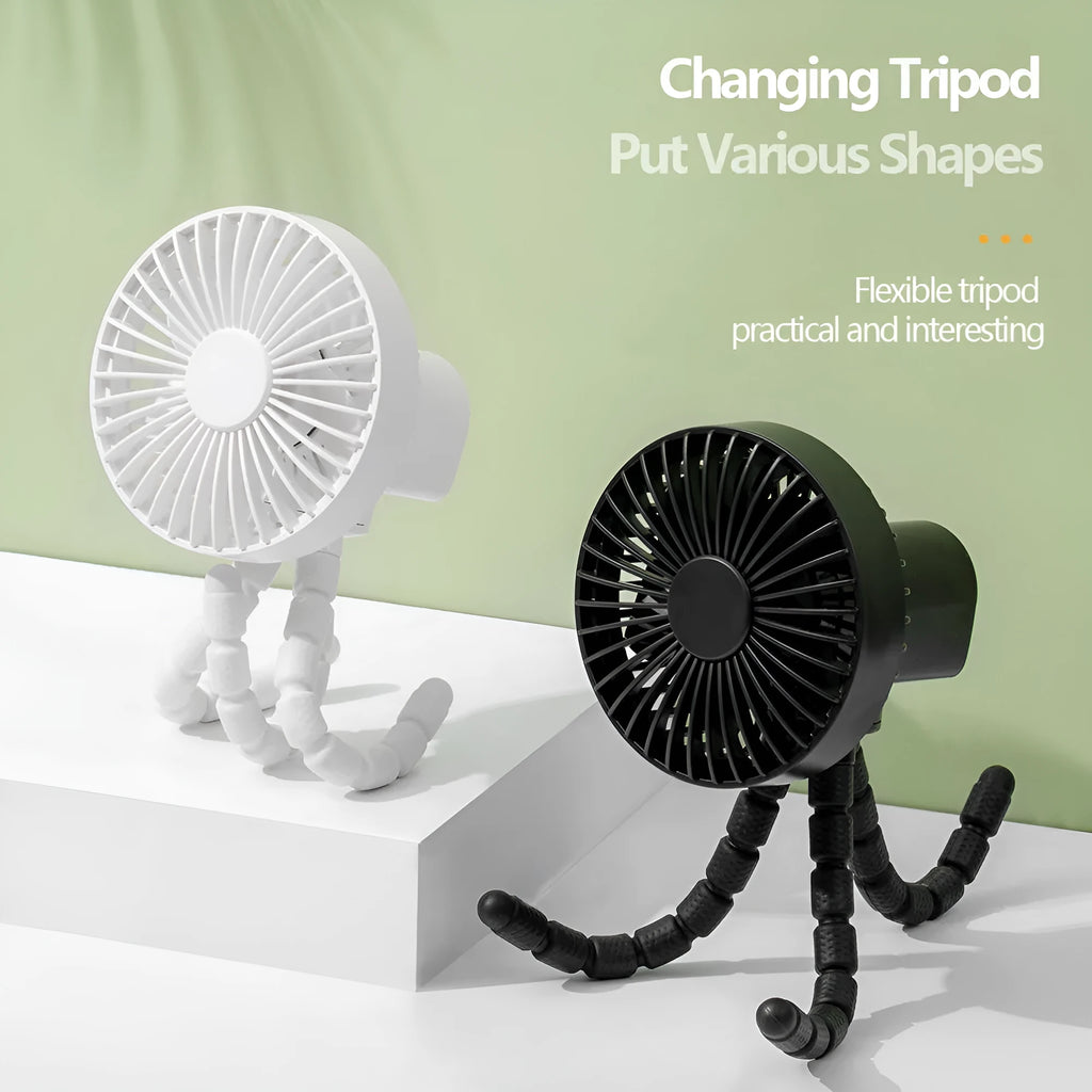 A small black adjustable desktop fan with flexible octopus tripod legs and a bending head on a wooden desk.