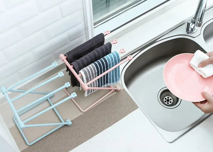 Foldable vertical dishcloth shelf in light blue with punch-free installation for kitchen organisation.