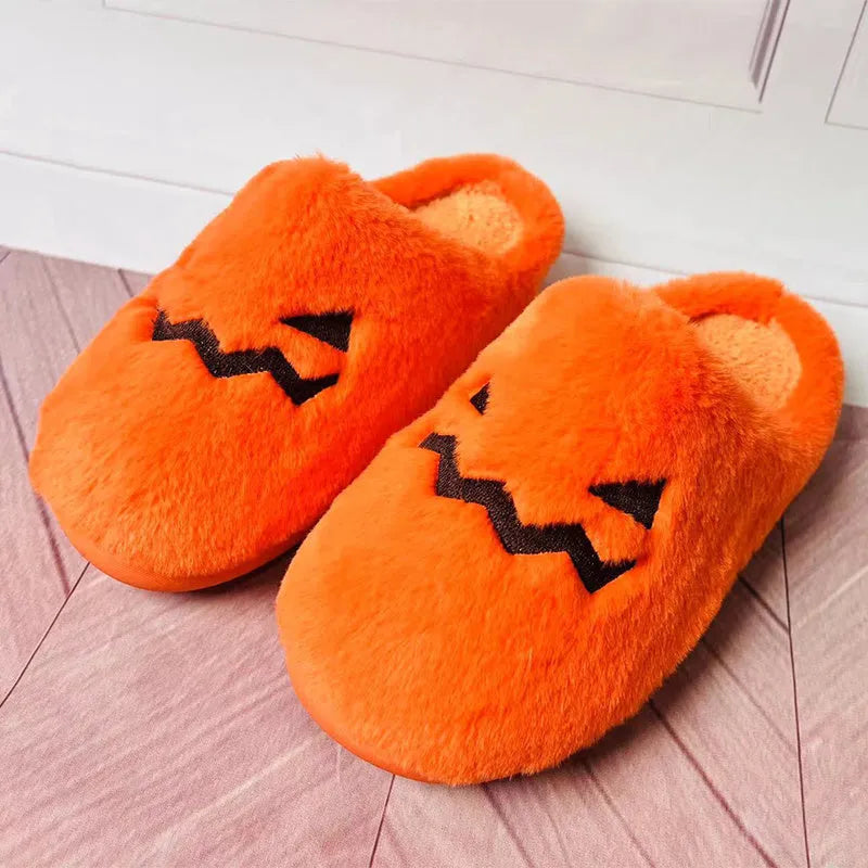 Orange Halloween pumpkin-themed plush indoor slippers with a non-slip PVC sole.
