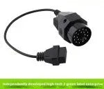 BMW 20-pin male to standard 16-pin OBD2 female diagnostic adapter cable on a workshop bench.