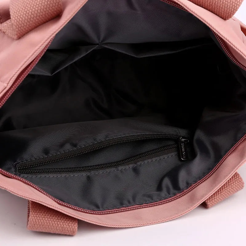 Nylon multi-interlayer shoulder bag in black with single strap and outer sandwich pocket, horizontal square shape